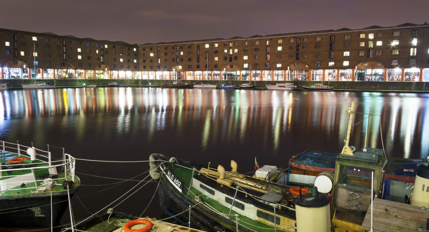 Liverpool, Merseyside, UK - February 19, 2009: Night scene of Albert Docks with reflections across the water on a cloudy winter night